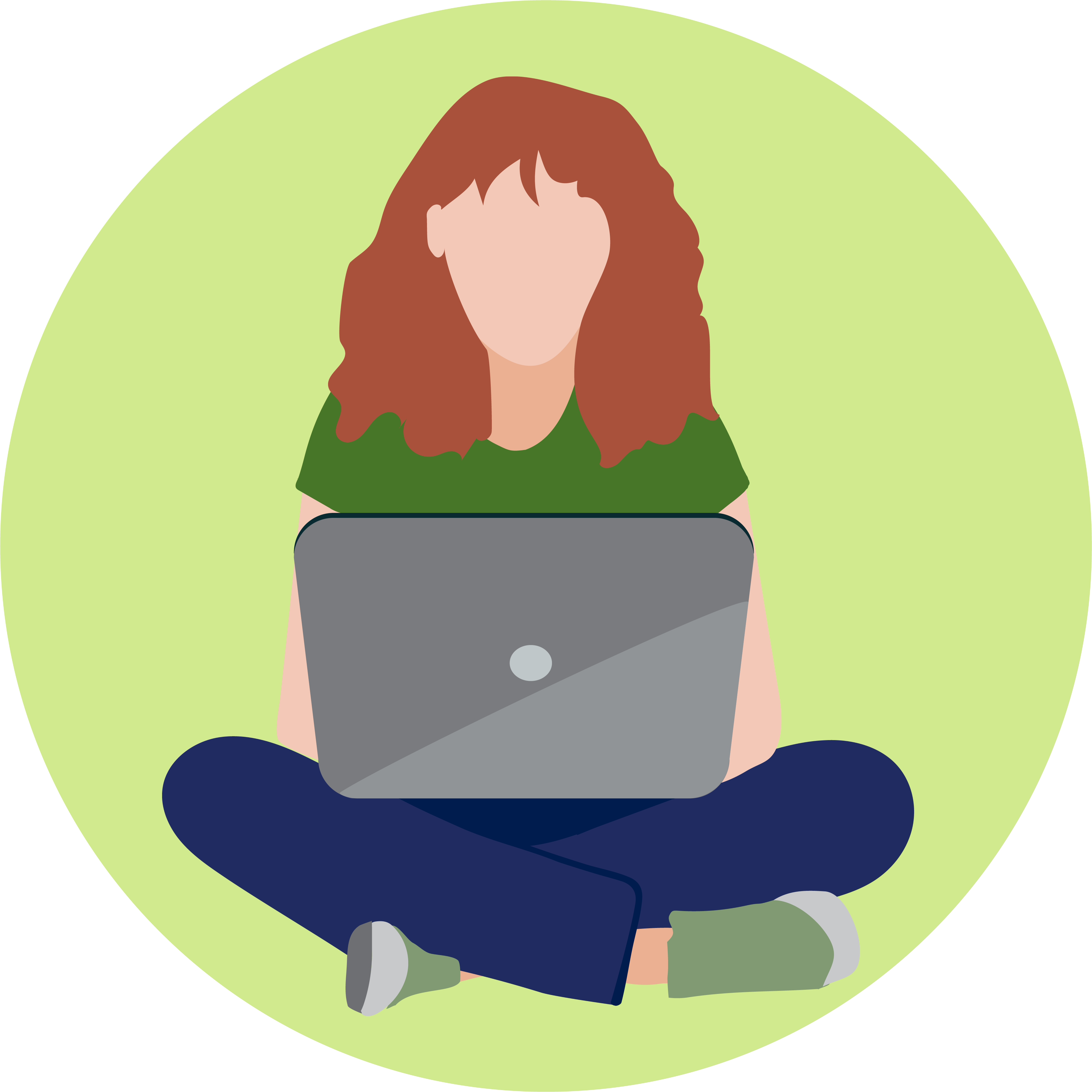 A woman with red hair sits cross legged, working on her laptop.